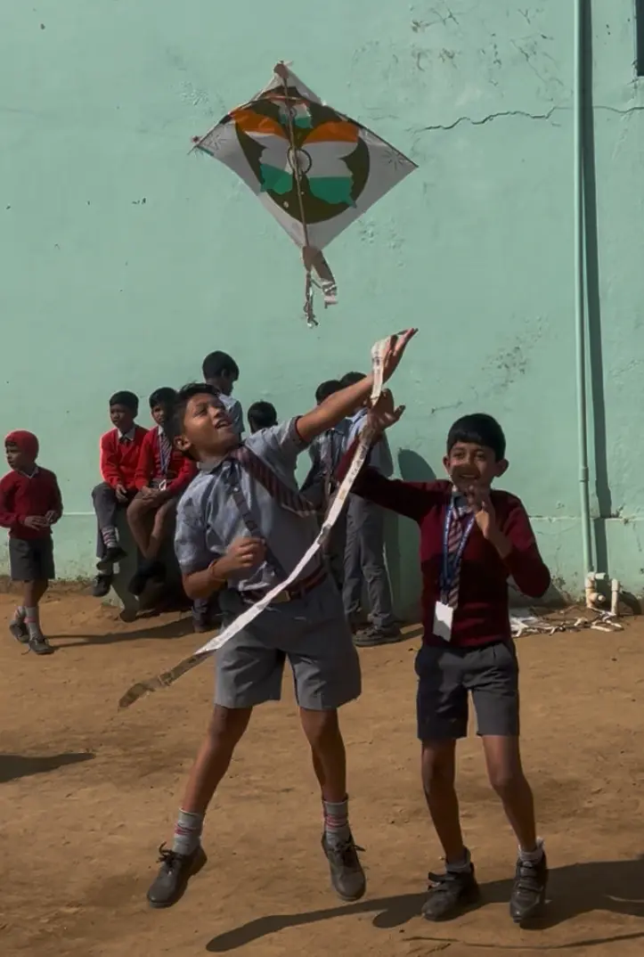 Students flying kites at school