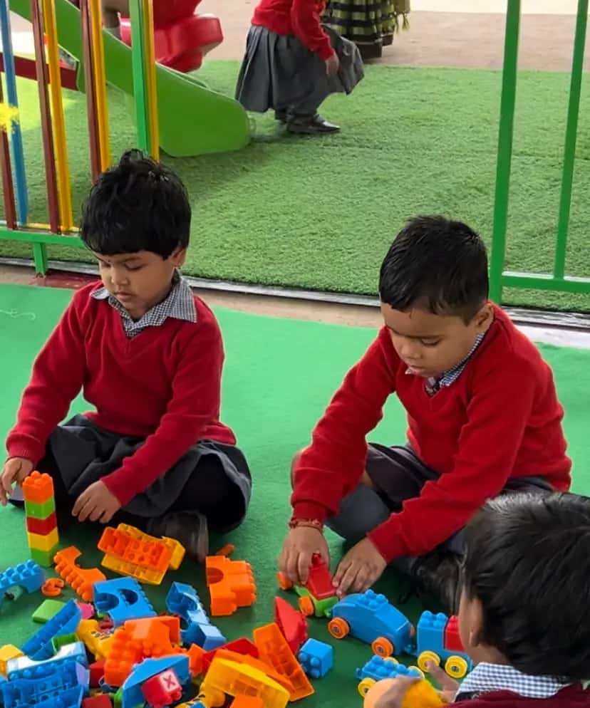 Pre-nursery children building with blocks